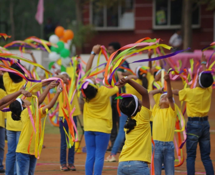 a group of people in yellow shirts holding streamers